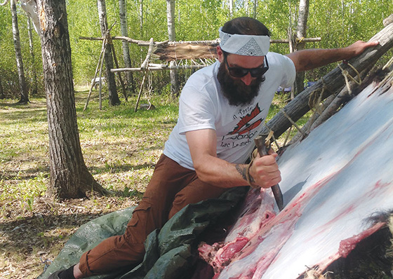 Cam Dobranski scrapes hide at the Cook It Raw event held this summer at Lac la Biche