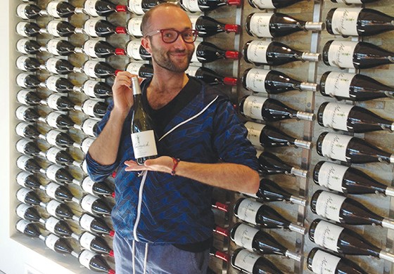 Mexican journalist Marck Guttman poses in front of Maverick’s wine wall