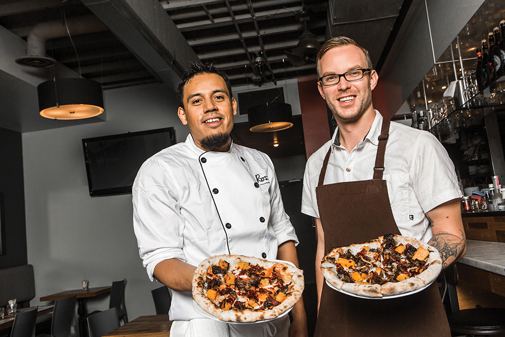 David Escamilla (L) and Brayden Kozak show off their pizzas