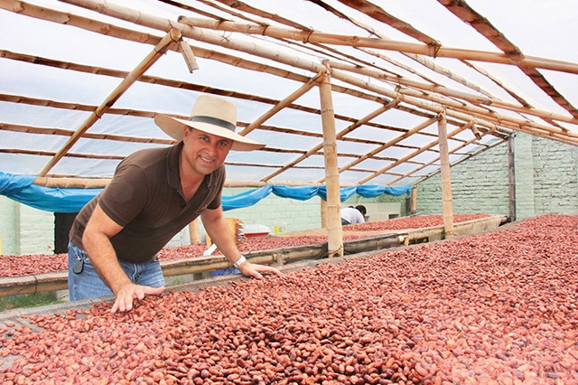 Samir Giha with drying Piura White cocoa beans in Santa Fe, Piura Department.