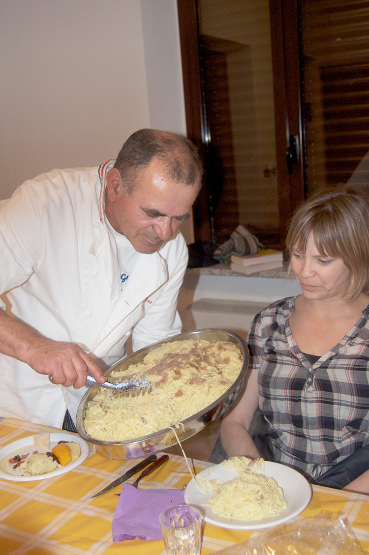 chef serves a modest portion of pasta to Cindy Lazarenko