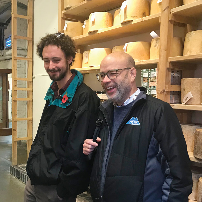 Nicolas and Brad in front of the wall of Stilton at Neal’s Yard Dairy, London.